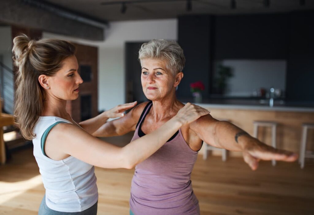 active senior woman with a trainer
